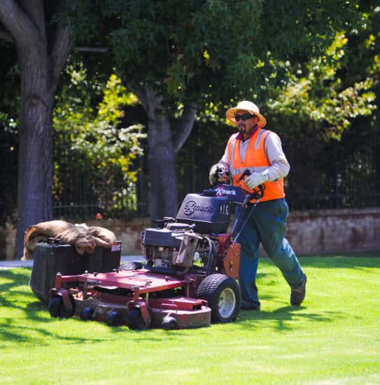 Landscaper mowing lawn